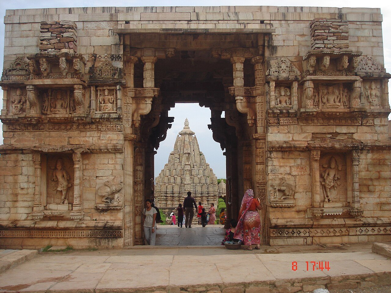 Carved gateway framing a temple spire inside Chittorgarh Fort
