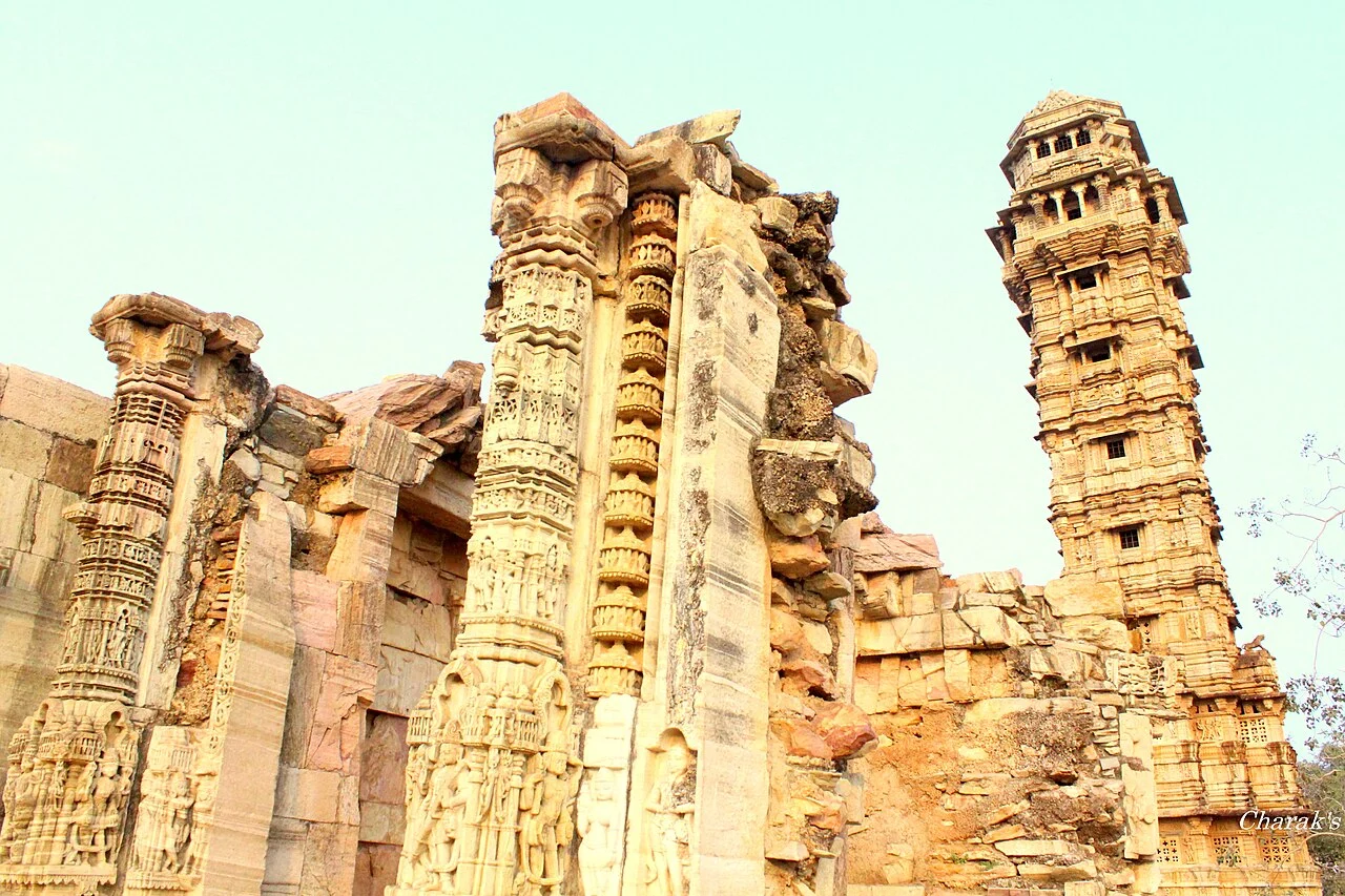 Carved temple ruins and the Vijaya Stambha, the Tower of Victory, inside Chittorgarh Fort in Rajasthan