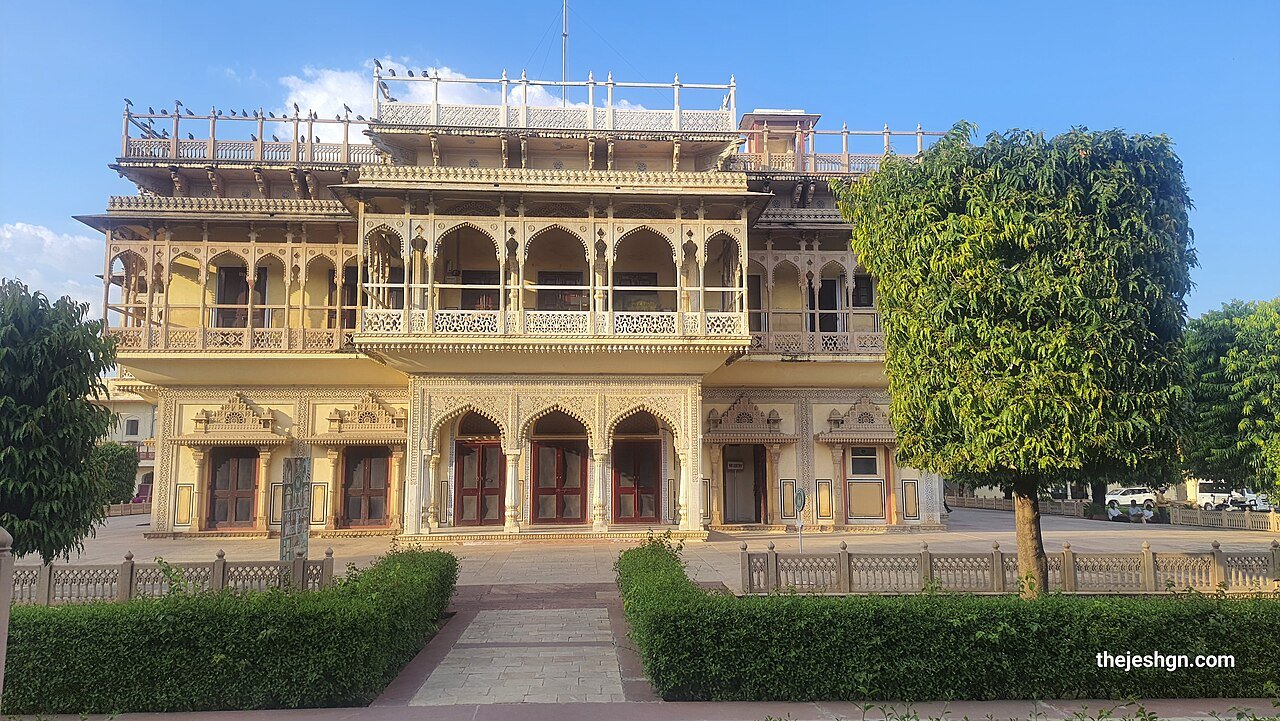 A multi-storey palace building behind hedges in Jaipur City Palace