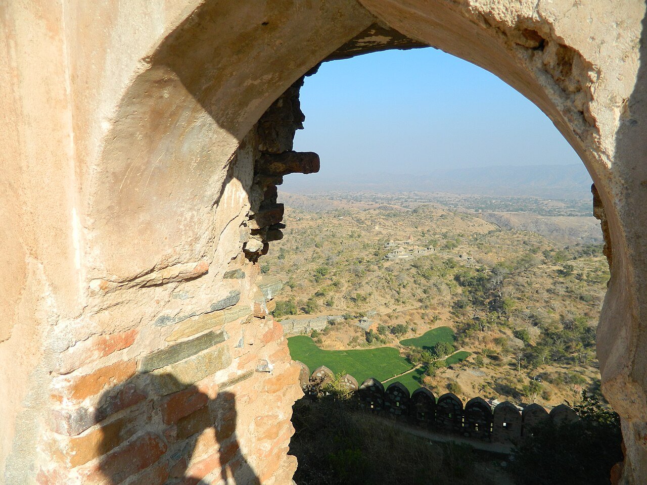 View through a stone arch at Kumbhalgarh Fort