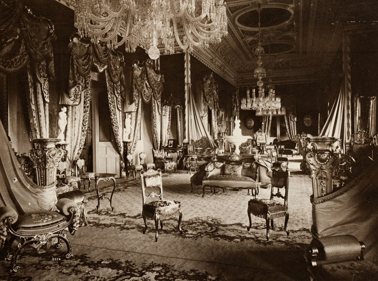 A historic photograph of a Falaknuma Palace interior