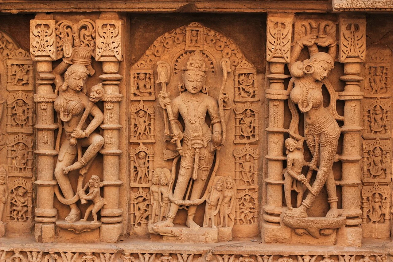 रानी की वाव की दीवार पर उकेरी गई चार भुजाओं वाली परशुराम की प्रतिमा, दोनों ओर स्त्री आकृतियाँ